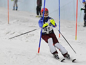 Ski racer skiing through gates