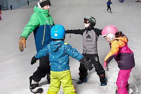 Group of children snowboarders with their snowboard instructor at Chill Factor<sup>e</sup>