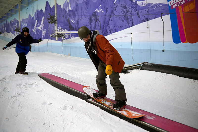 Snowboarder riding a box