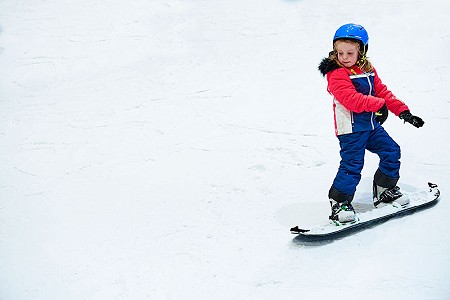 Child riding a snowboard