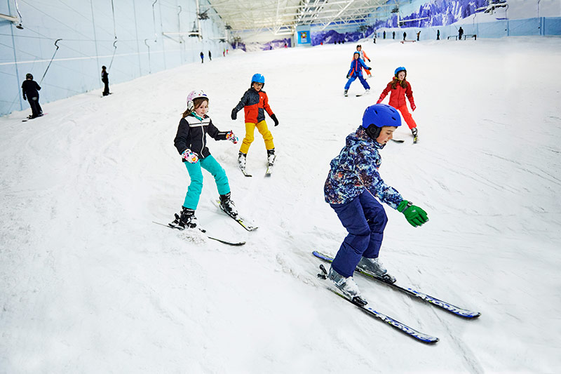 Group of people learning to Alpine ski at Chill Factor<sup>e</sup> indoor ski slope