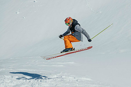 Neilson Mountain Expert in mid-air about to land a jump