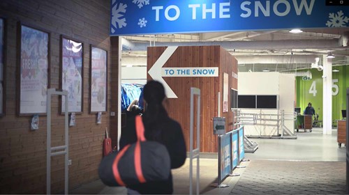 The inside entrance of chill factore indoor ski slope with an arrow pointing towards the slope