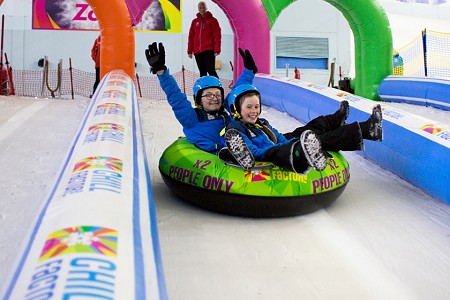 Children having fun in snow park