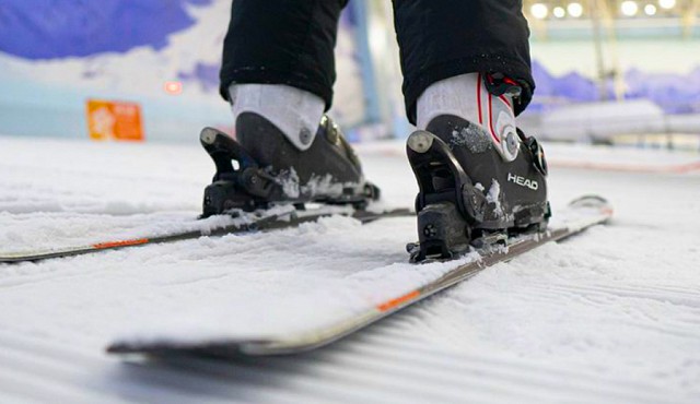 Shot of a persons lower legs in ski boots on skis, sliding on freshly groomed snow at Chill Factor<sup>e</sup>