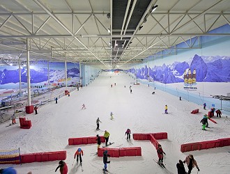 Aerial view of people skiing down the slope at chill factore indoor ski slope, Manchester
